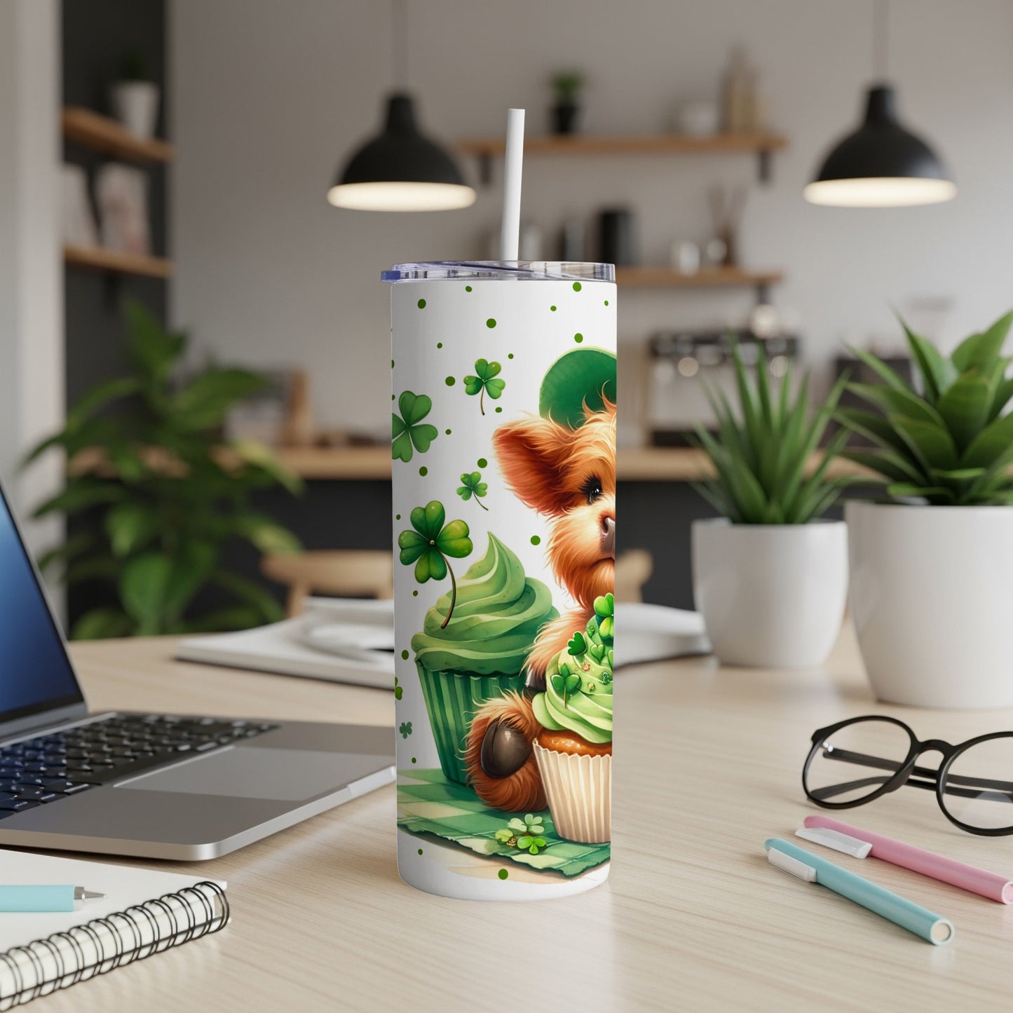 Cupcake with dog and shamrocks on a St. Patrick's Day themed tumbler.