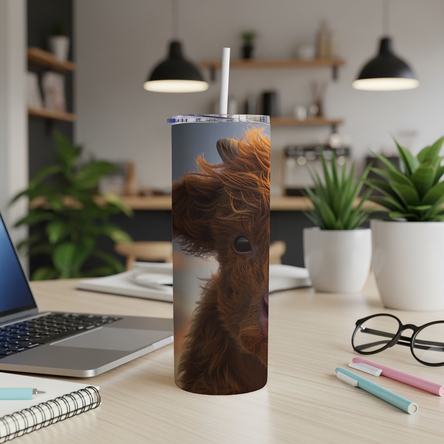Highland calf on a tall, insulated tumbler with straw.