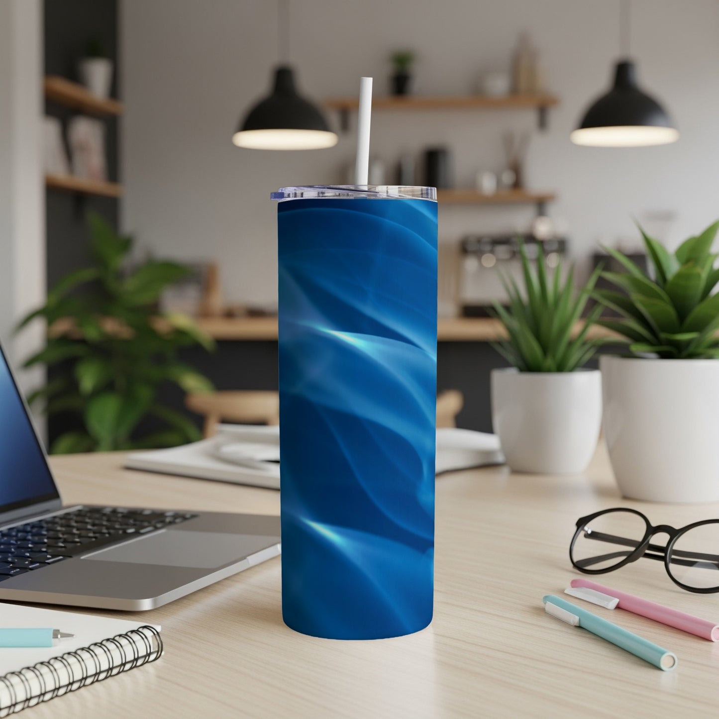 Blue abstract pattern on a stainless steel tumbler with straw.