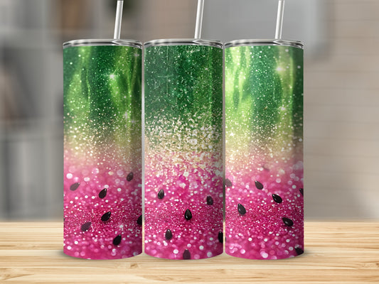 Three tumblers with a watermelon and glitter design on a wooden surface.