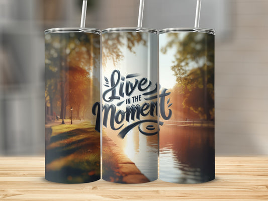 Tumbler with "Live in the Moment" text and sunlit park scene.