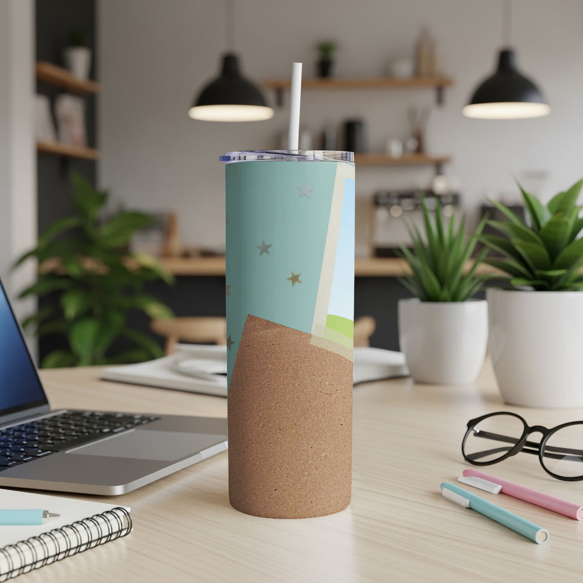 Tall tumbler with a straw, featuring a pastel design with stars and a cork-textured bottom.