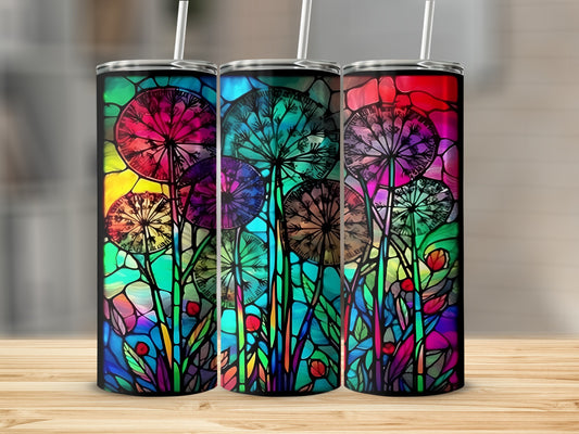 Three colorful tumblers with stained-glass dandelion designs on a wooden surface.