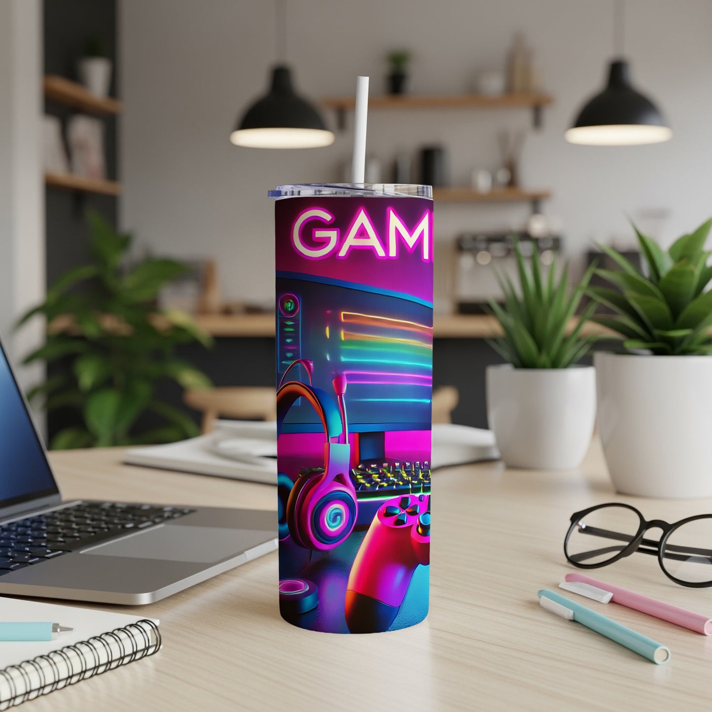 Purple and pink tumbler with "GAM" text, featuring gaming accessories on a desk.