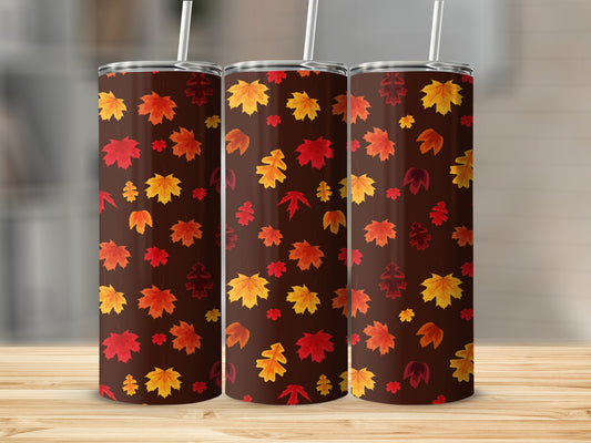 Three brown tumblers with repeating autumn leaf pattern.