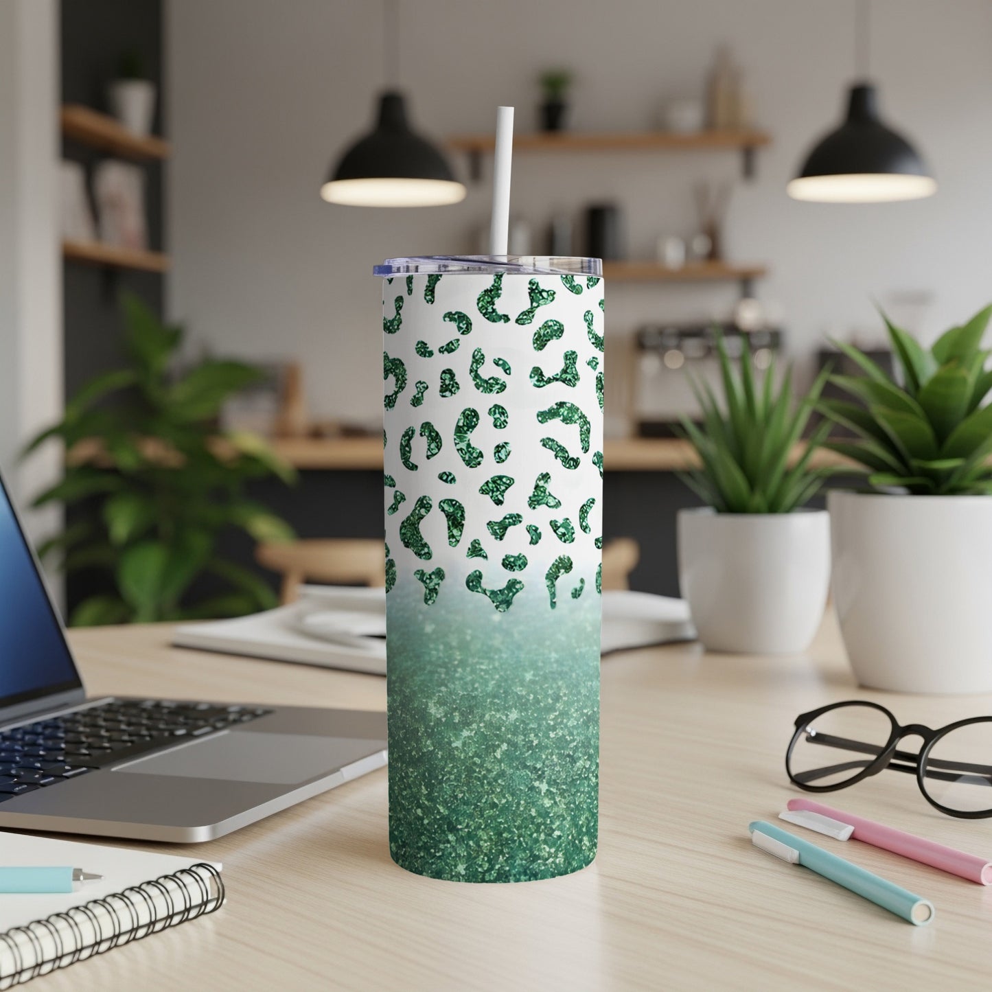 Green glitter leopard print tumbler with white lid and straw.