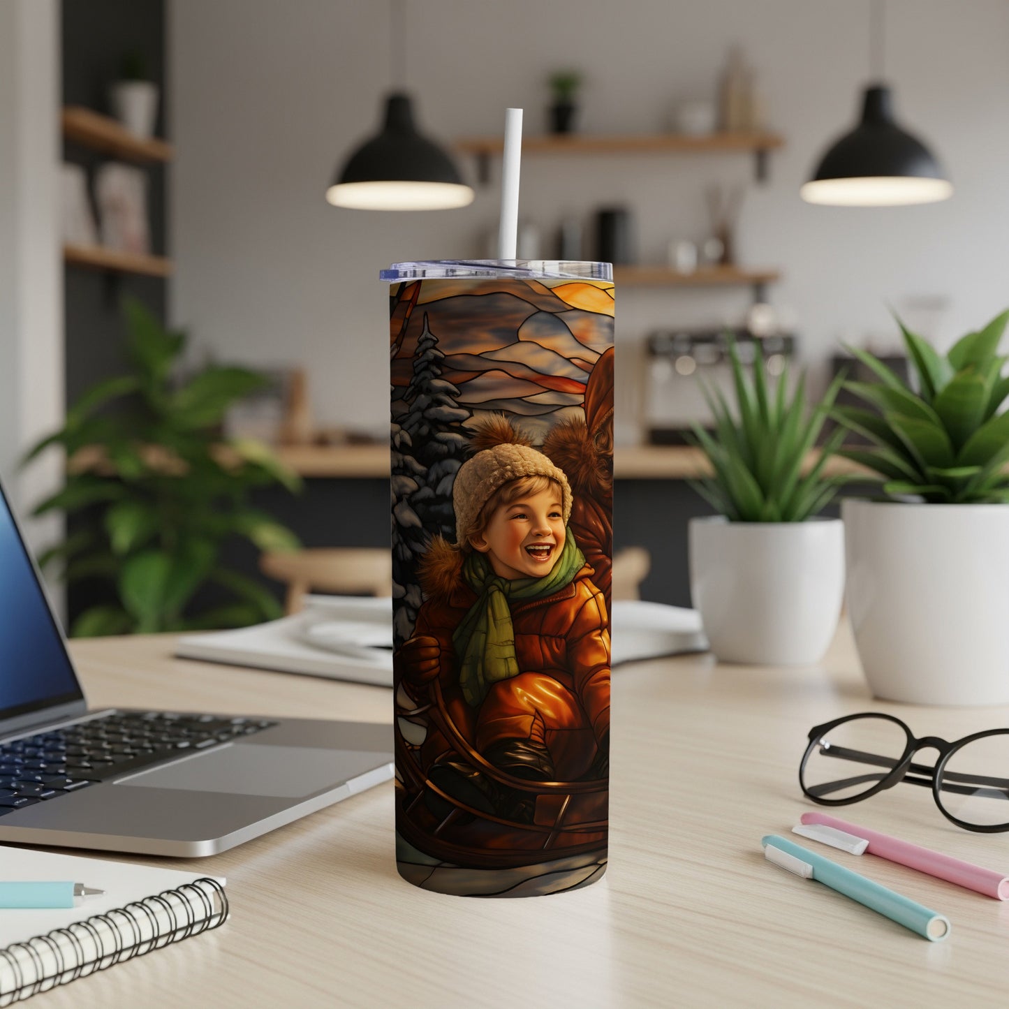 Smiling child in a sled with a winter scene on a stainless steel tumbler.