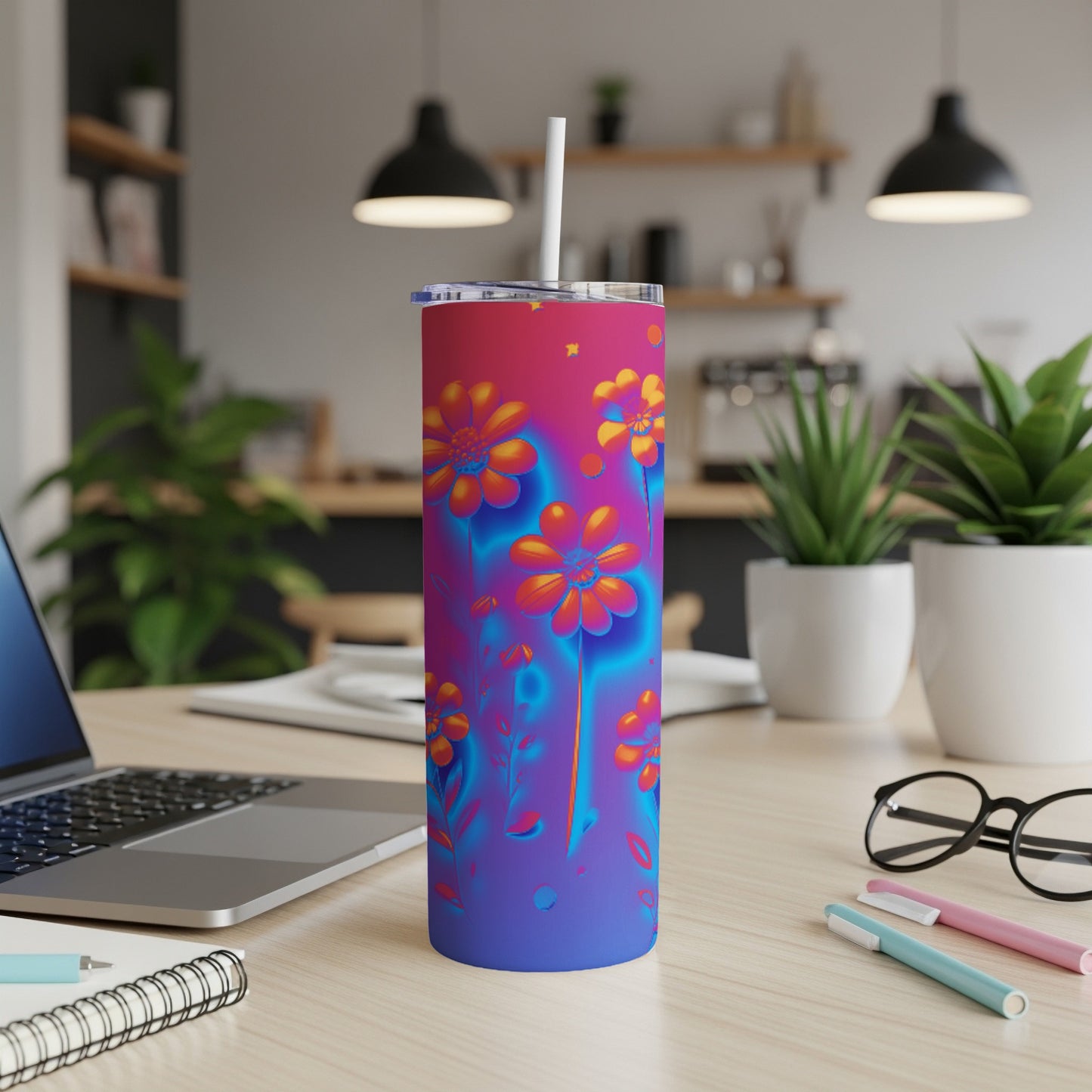 Tall tumbler with vibrant floral pattern and a straw.