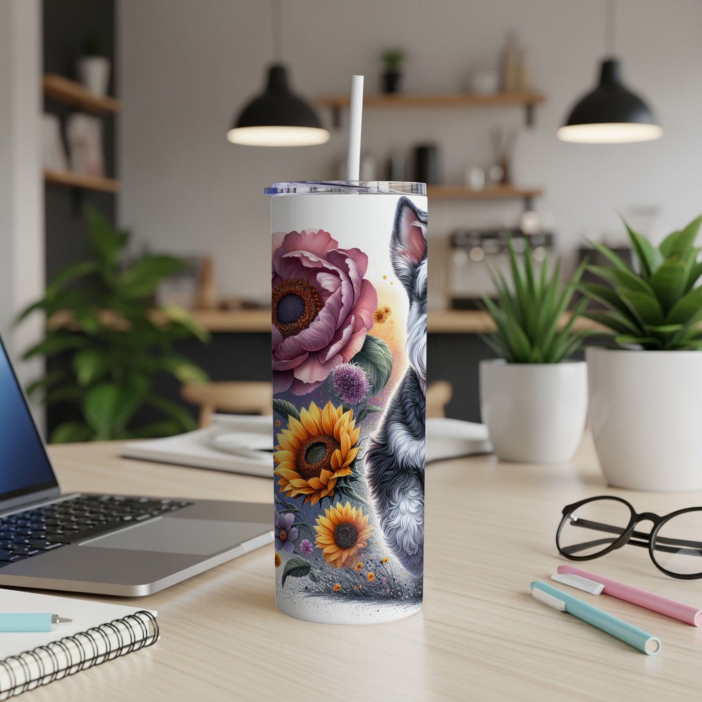 Tall tumbler with wolf, sunflowers, and floral art on a desk.