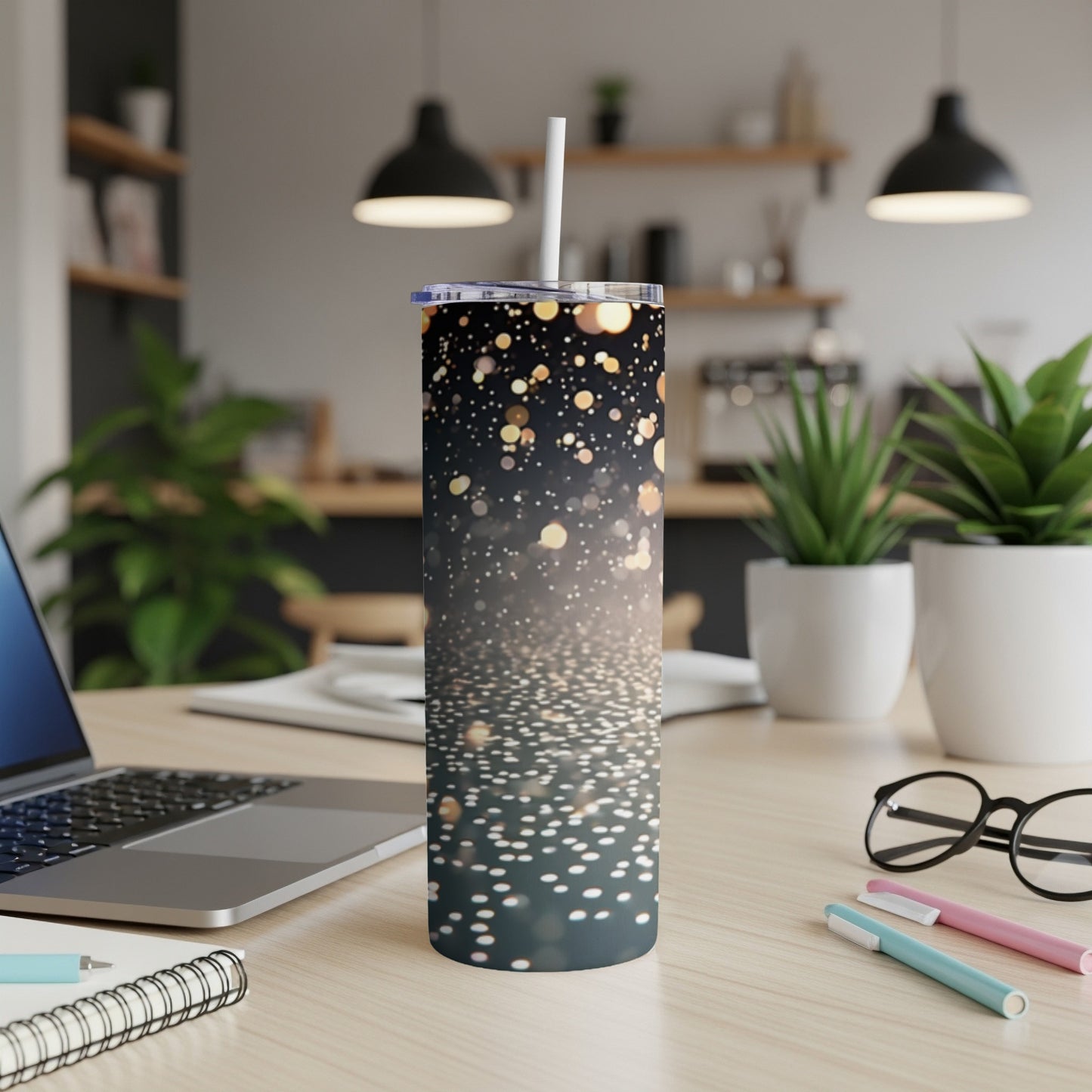 Glittering bokeh effect on a stainless steel tumbler with a straw.