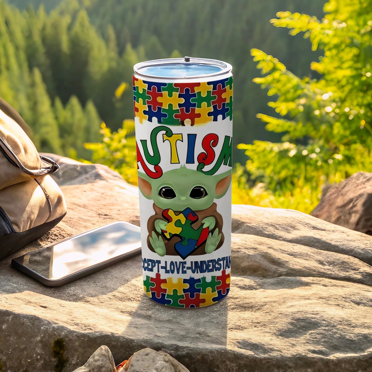 Autism awareness tumbler with puzzle pieces, frog character, and text.