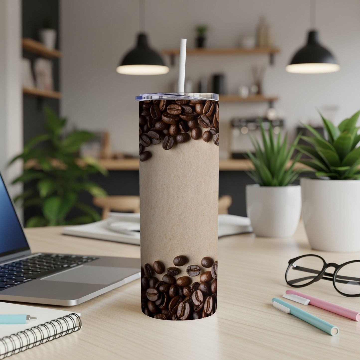 Tall tumbler with coffee beans around the upper portion.