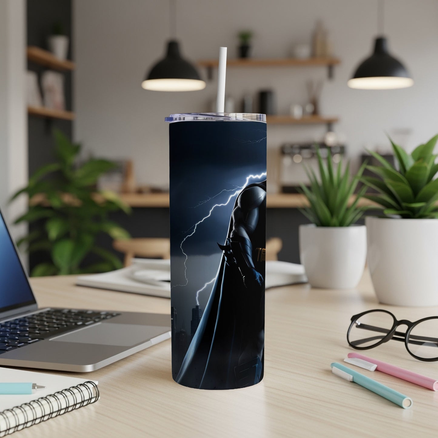 Batman silhouette against stormy city skyline on a black tumbler.