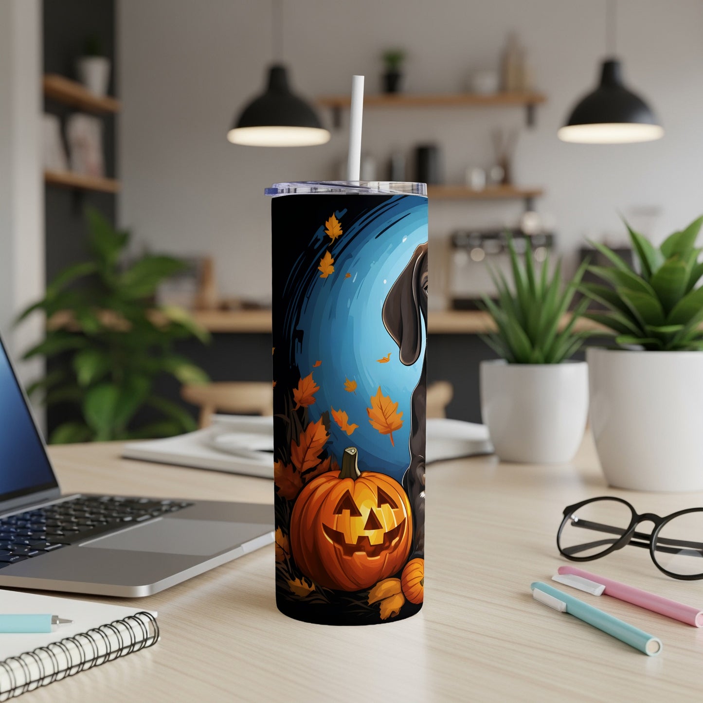 Black tumbler with pumpkin, dog, and falling leaves Halloween design.