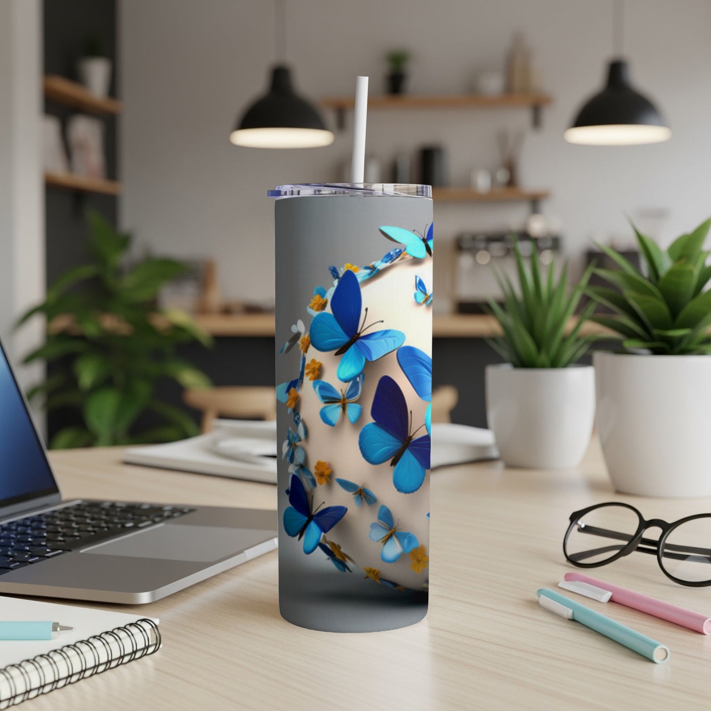 White tumbler with blue butterflies and yellow flowers.