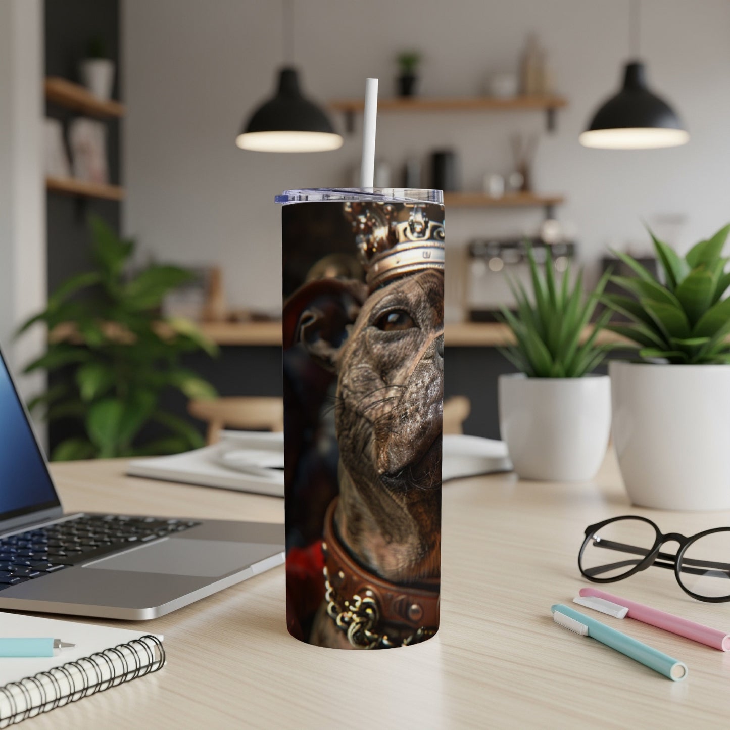 Dog wearing a crown on a tumbler with a straw.