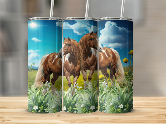 Three tumblers with horses in a field, on a wooden surface.