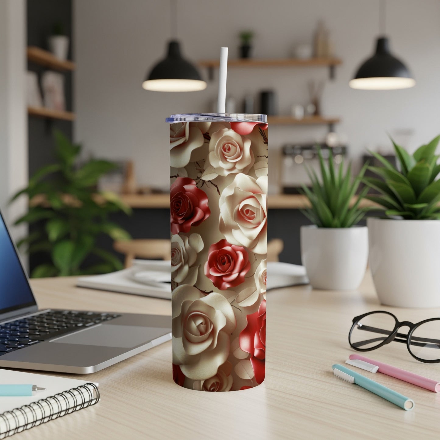 White and red rose pattern on a stainless steel tumbler with a straw.