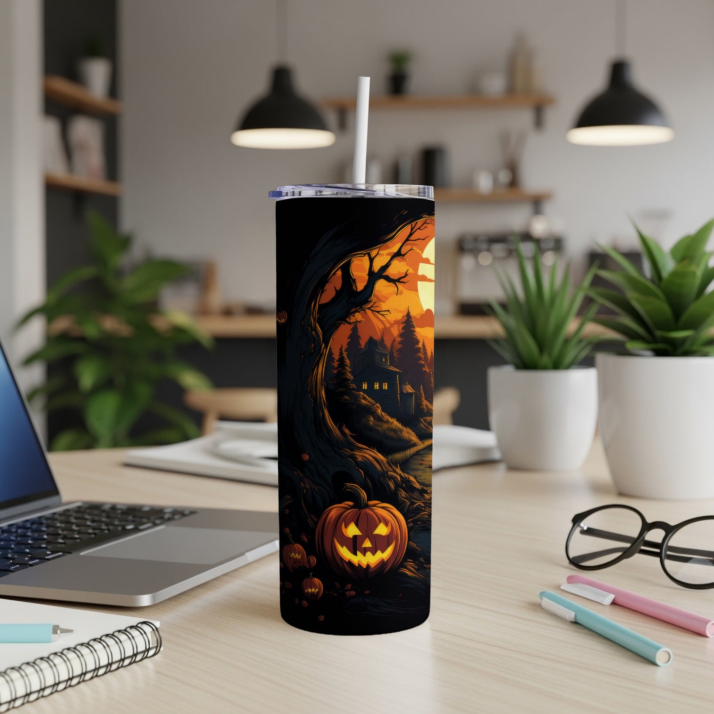 Halloween tumbler with a spooky scene featuring pumpkins and a haunted house.