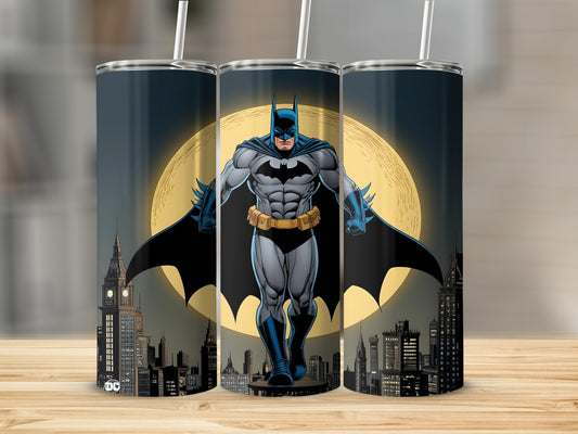 Batman standing in front of a full moon and city skyline.