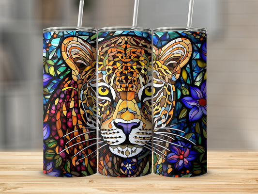 Leopard stained glass art on a tumbler with straws.