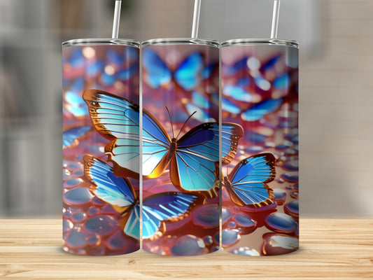 Three tumblers with iridescent blue butterflies and water droplets.