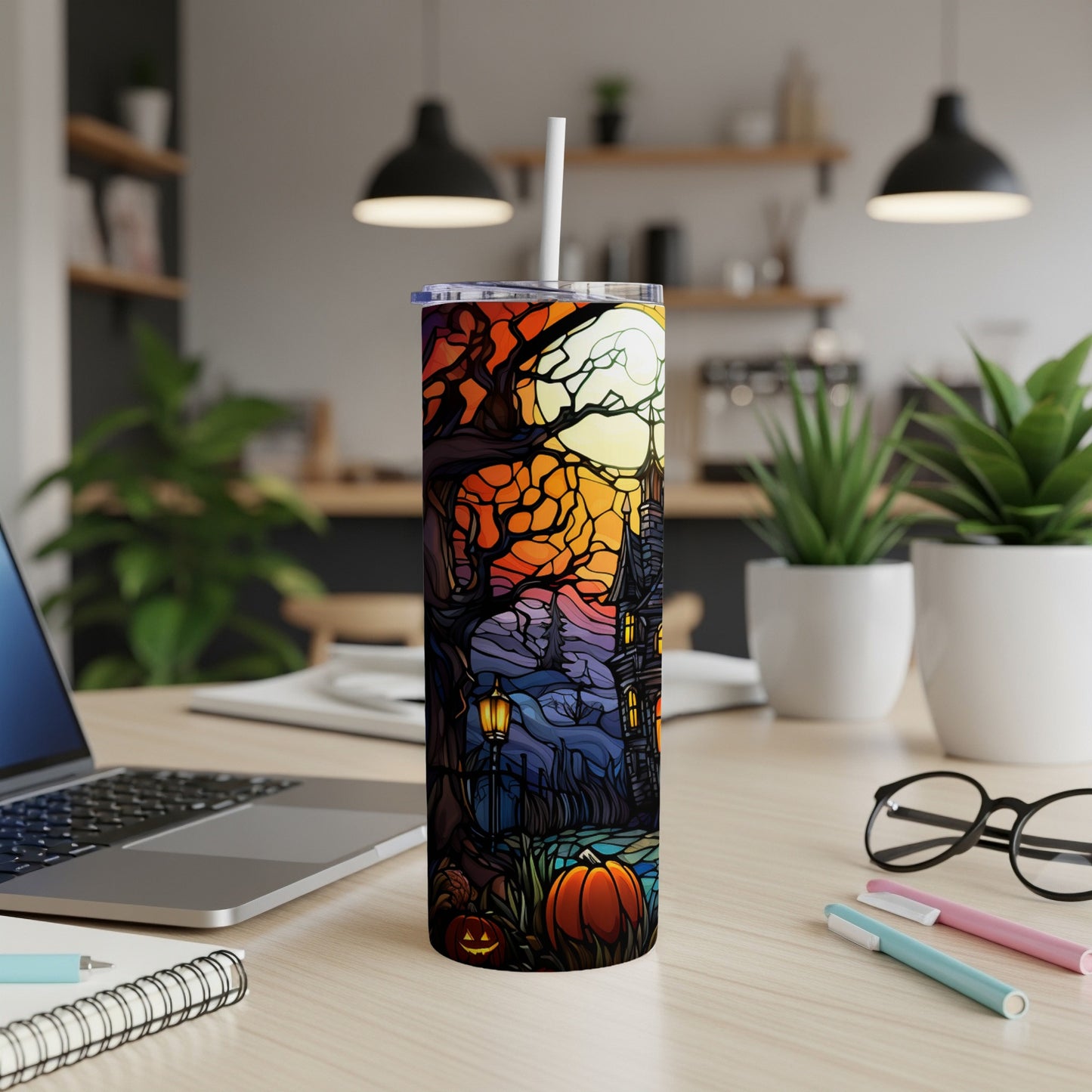 Halloween tumbler with spooky house, pumpkin, and moon design.