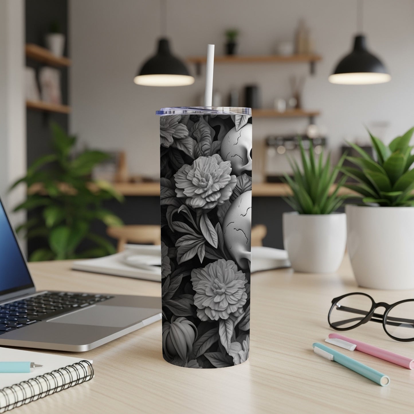 Skulls and flowers pattern on a white tumbler with a straw.