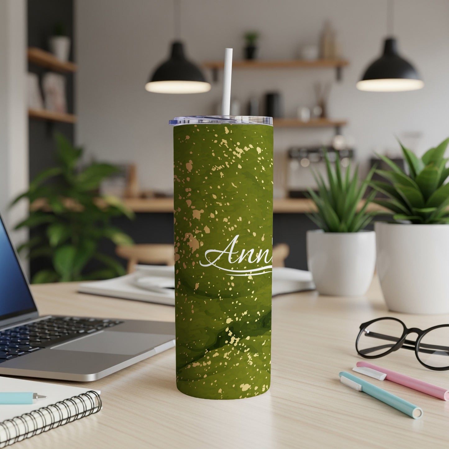 Green marbled tumbler with "Ann" in gold script on a desk.