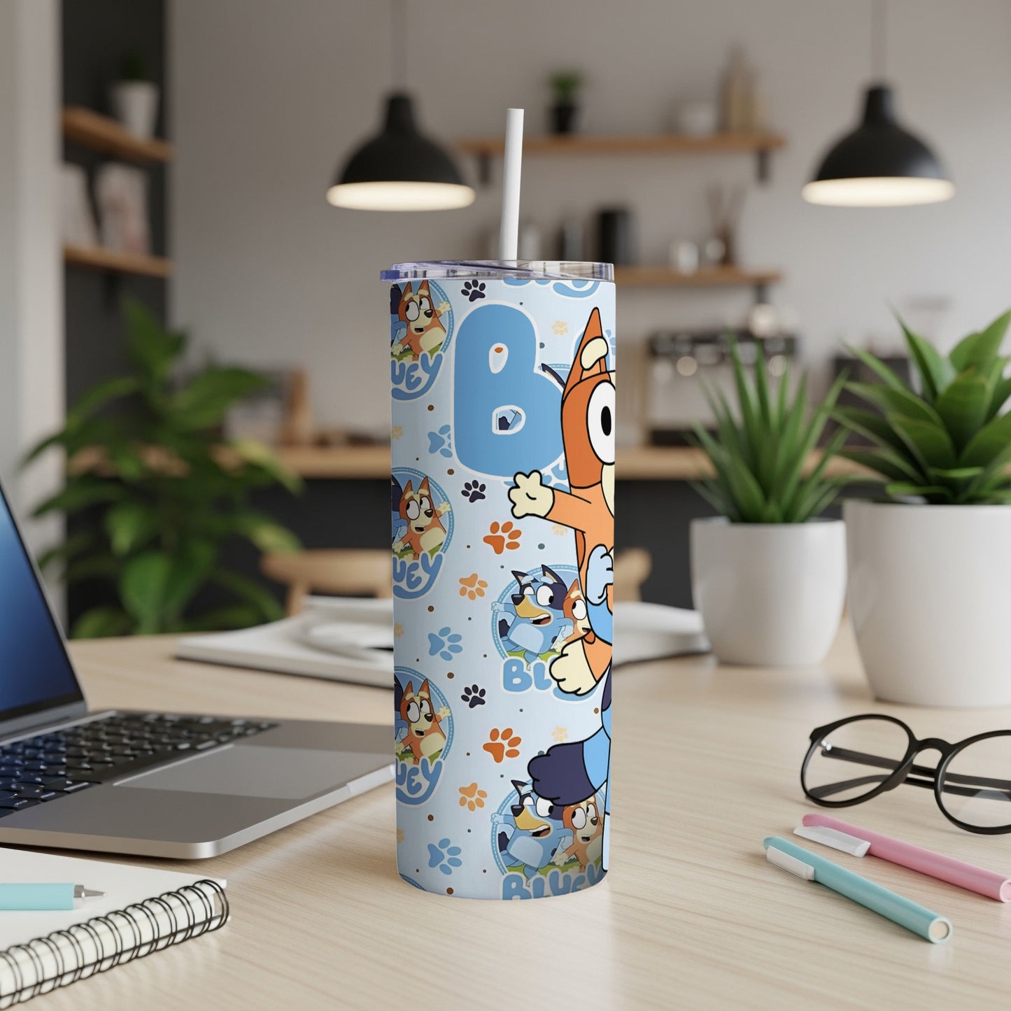 Bluey and Bingo cartoon characters on a light blue patterned tumbler.