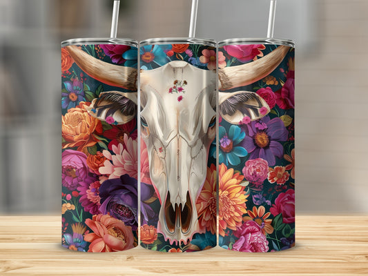 Bull skull with floral pattern on three tumblers on a wooden surface.