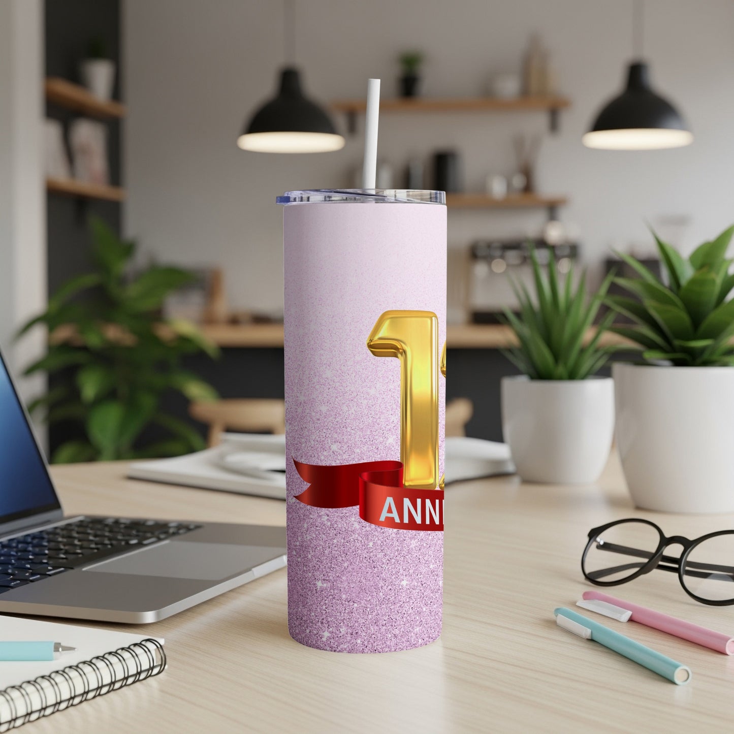 Pink glitter tumbler with "1 ANNIVERSARY" text and red ribbon.
