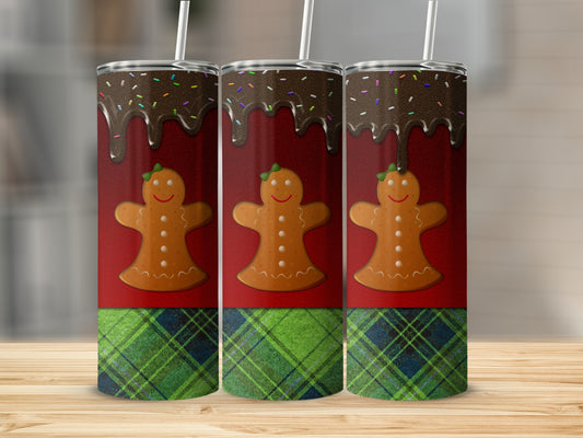Three gingerbread men with chocolate and sprinkles on a red and plaid background.