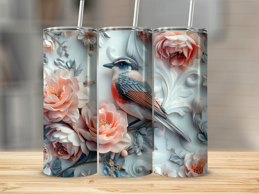 Three floral tumblers with a bird illustration on a wooden surface.
