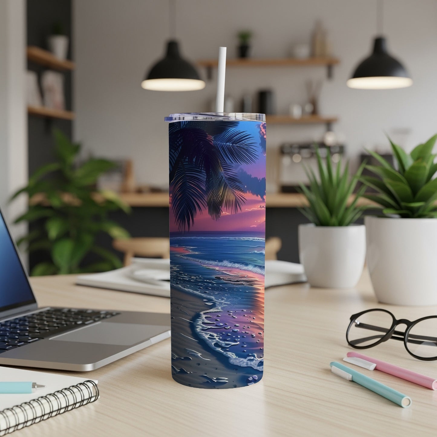 Beach sunset design on a skinny tumbler with straw, on a desk.