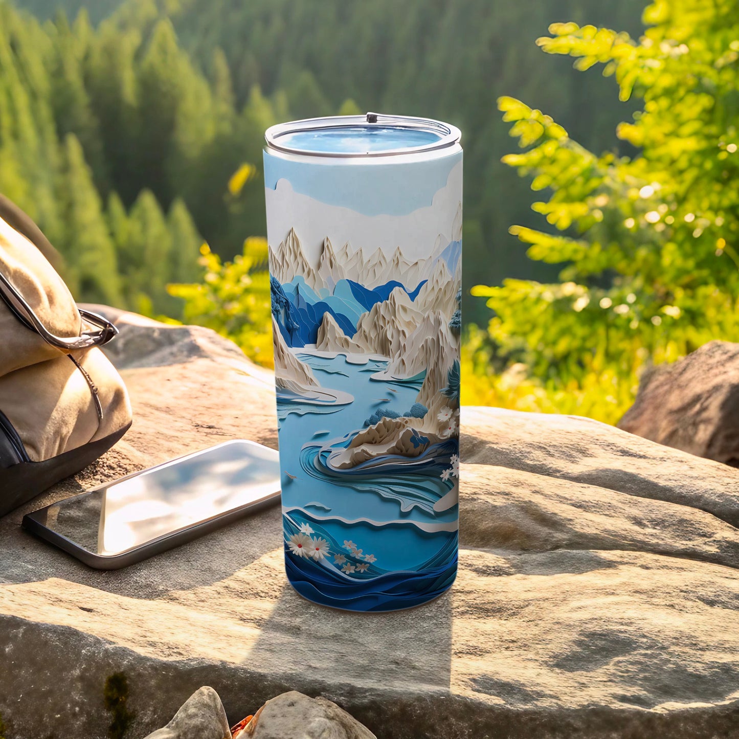 Scenic mountain landscape tumbler with floral accents on a rock.