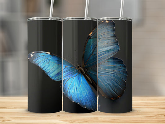 Close-up of a vibrant blue butterfly on a black tumbler.