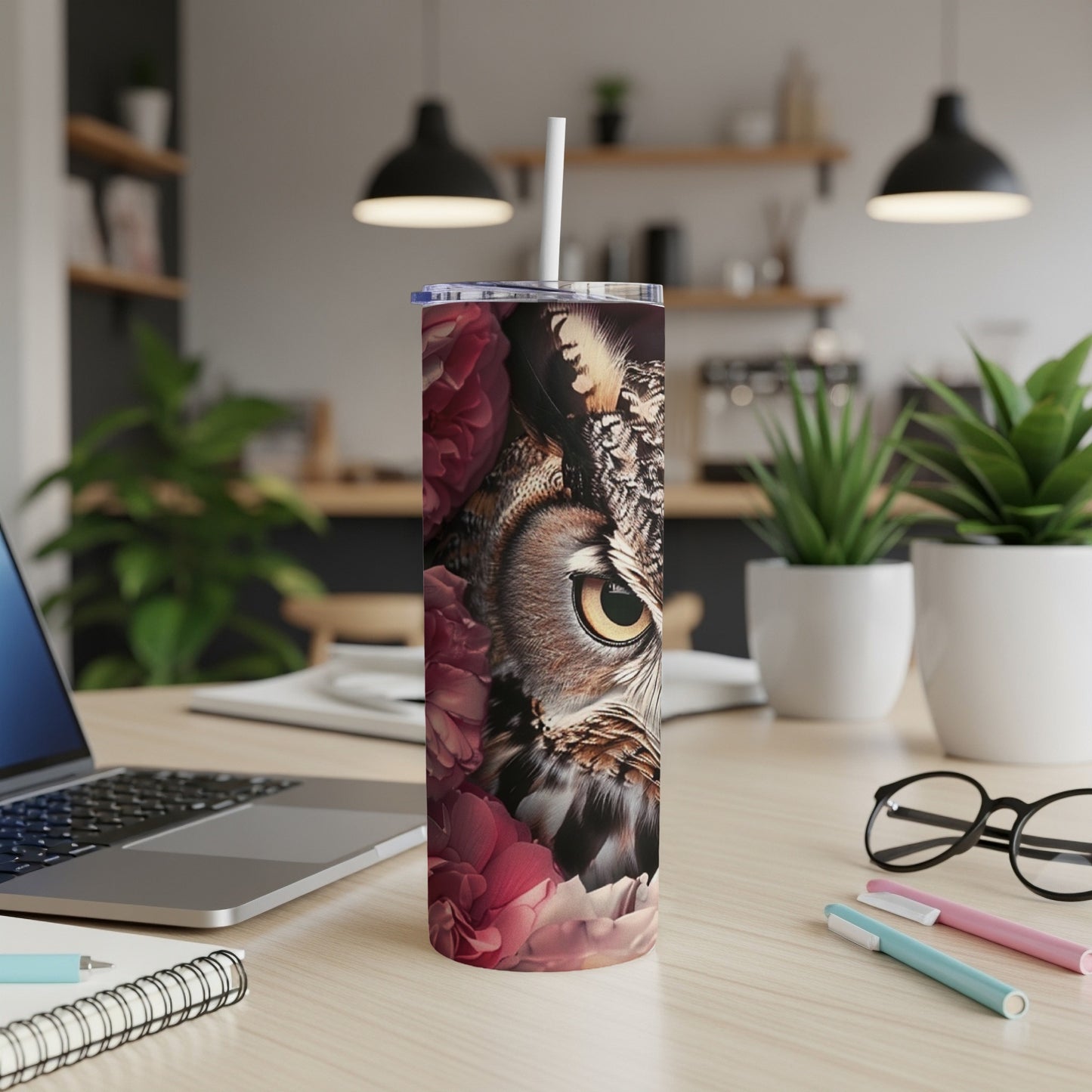 Owl and floral design on a white skinny tumbler with a straw.