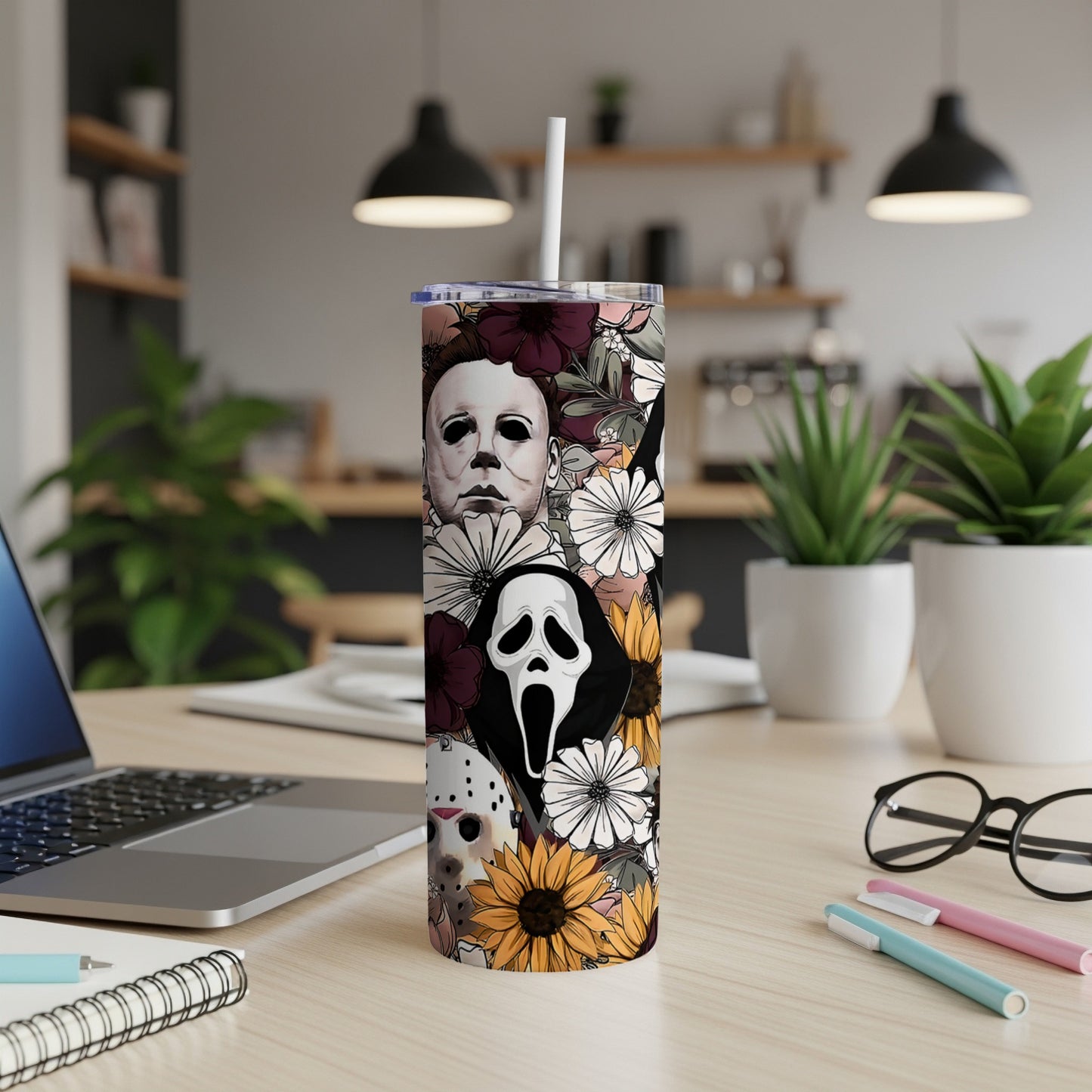 Tumbler featuring horror icons Michael Myers, Ghostface, and Jason Voorhees with floral accents.