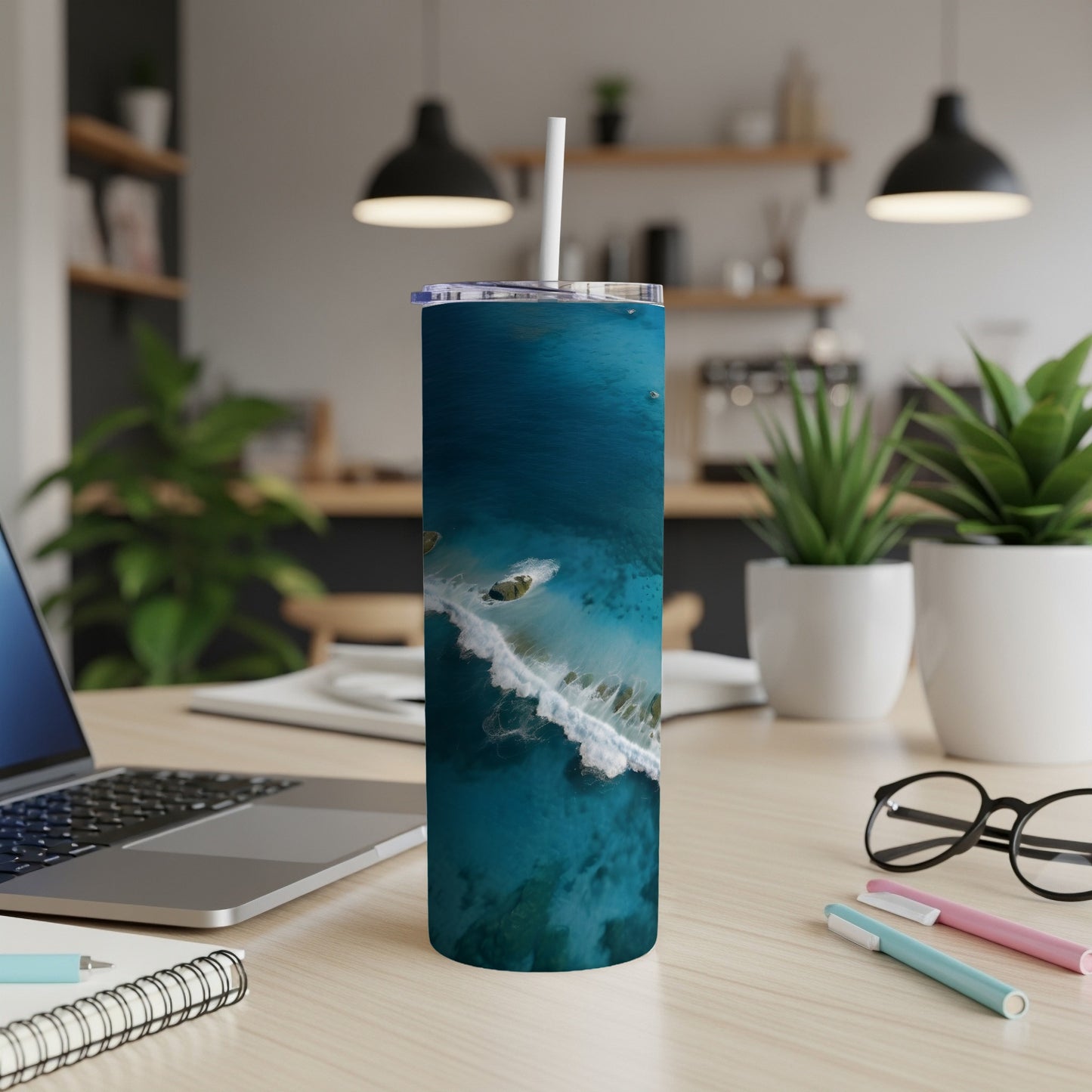 Tumbler with aerial view of a breaking wave and boats on turquoise water.