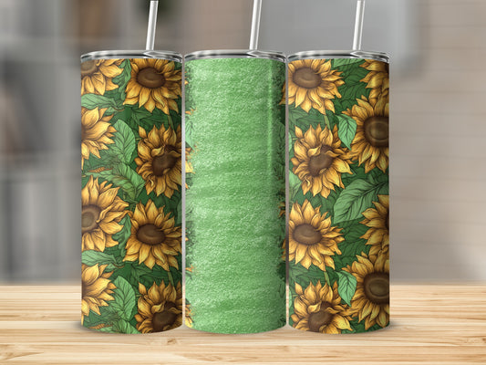 Sunflower pattern tumbler with green textured center against wooden background.