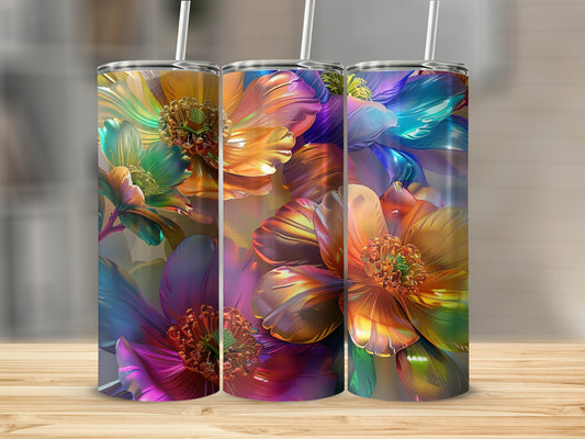 Three tumblers with colorful, textured floral designs on a wooden surface.