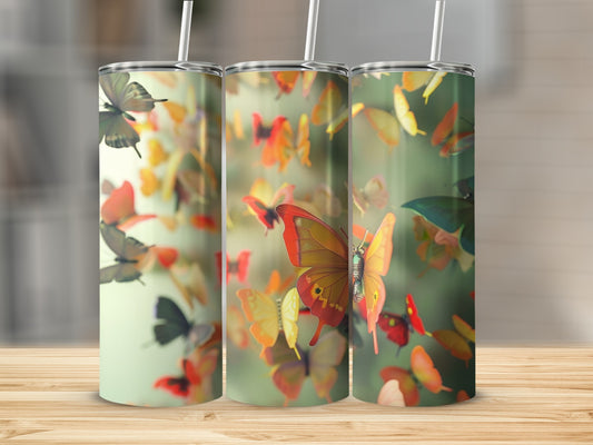 Three tumblers with a colorful butterfly pattern and white straws.