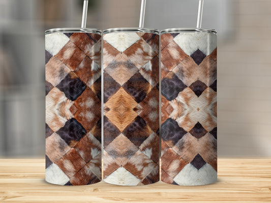 Three tumblers with a diamond-shaped cowhide pattern, on a wooden surface.