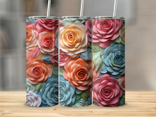 Three tumblers with colorful, layered rose floral patterns on a wooden surface.