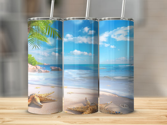Beach scene tumbler with starfish and palm fronds on a wooden surface.