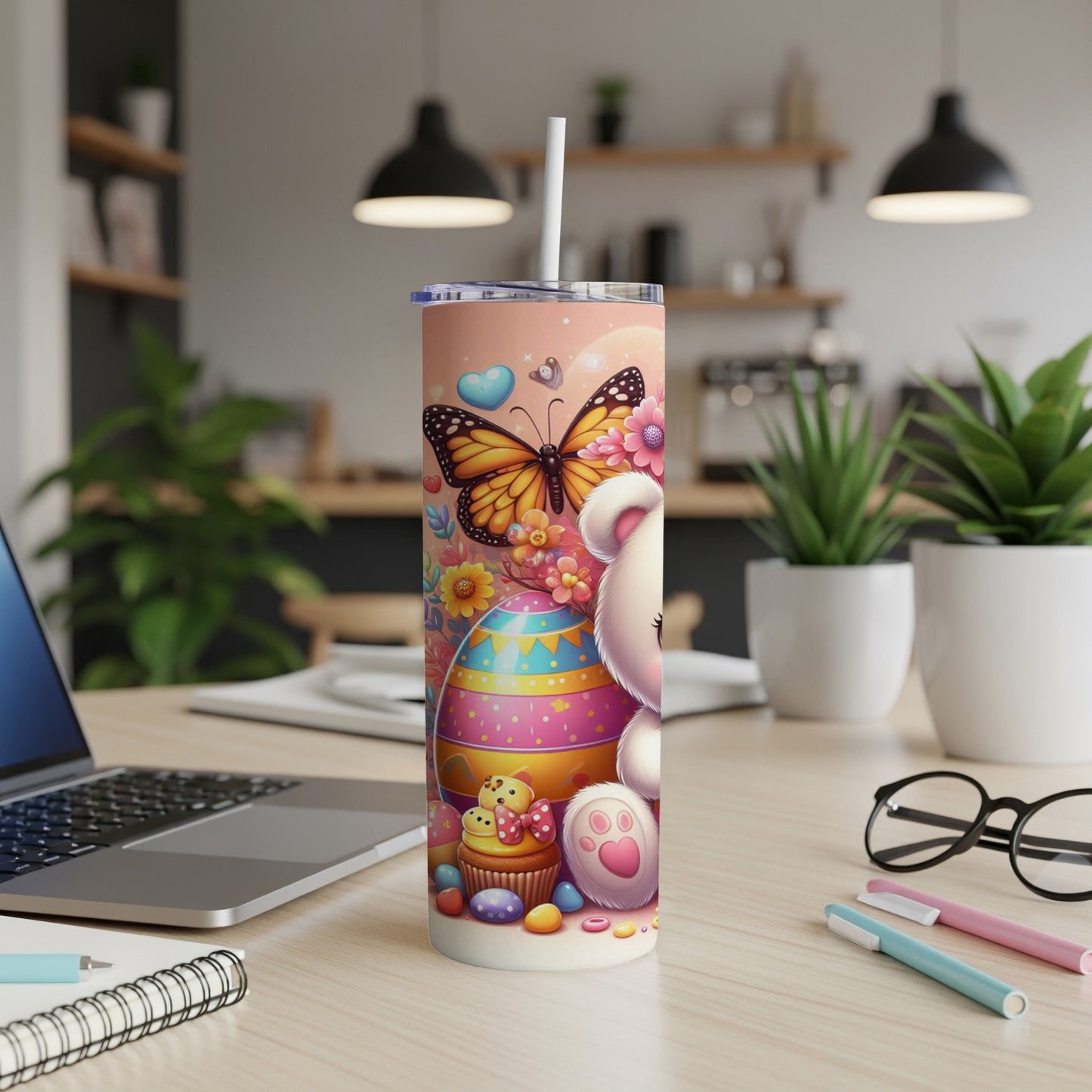 White teddy bear with butterfly, Easter eggs, and cupcakes on a tumbler.