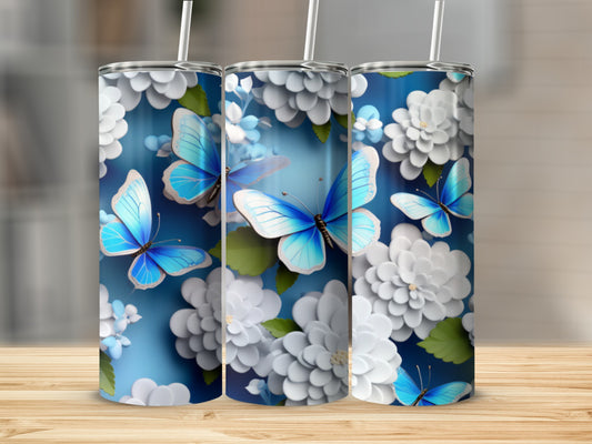Three tumblers with blue butterflies and white flowers on a blue background.