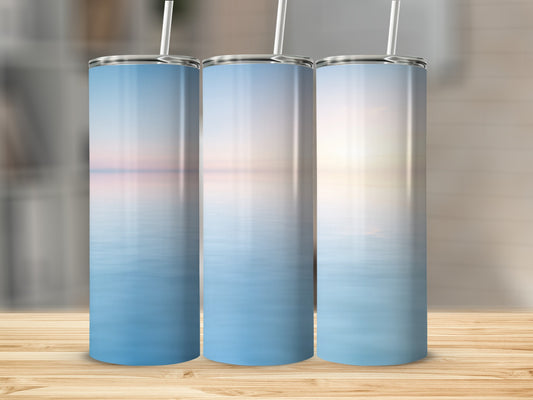 Three tumblers with a serene ocean sunset design.
