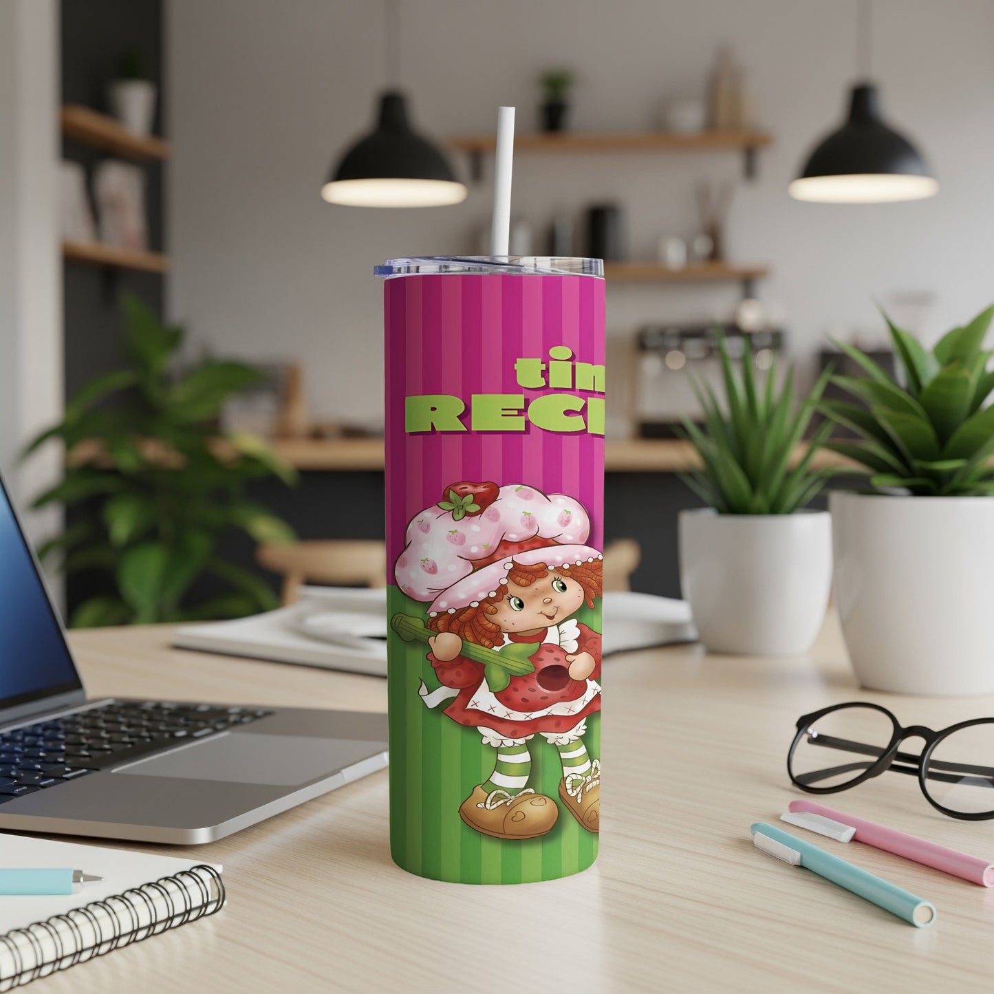 Strawberry Shortcake tumbler with recipe text on a desk.